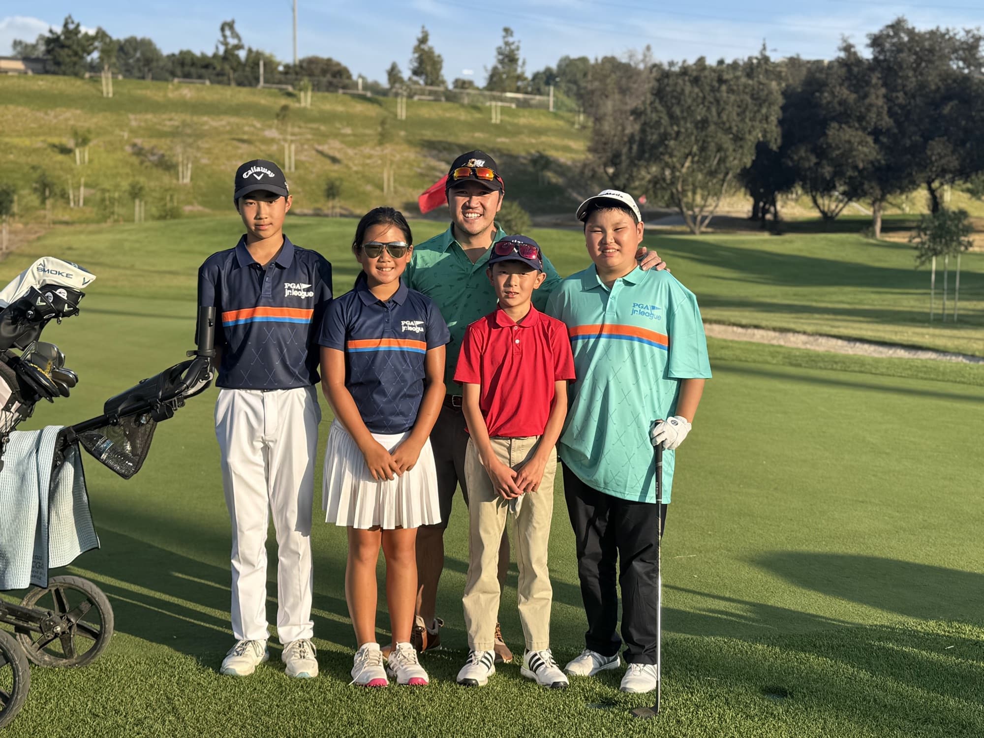 A Jucchou Golf coach with PGA Junior League players on the course