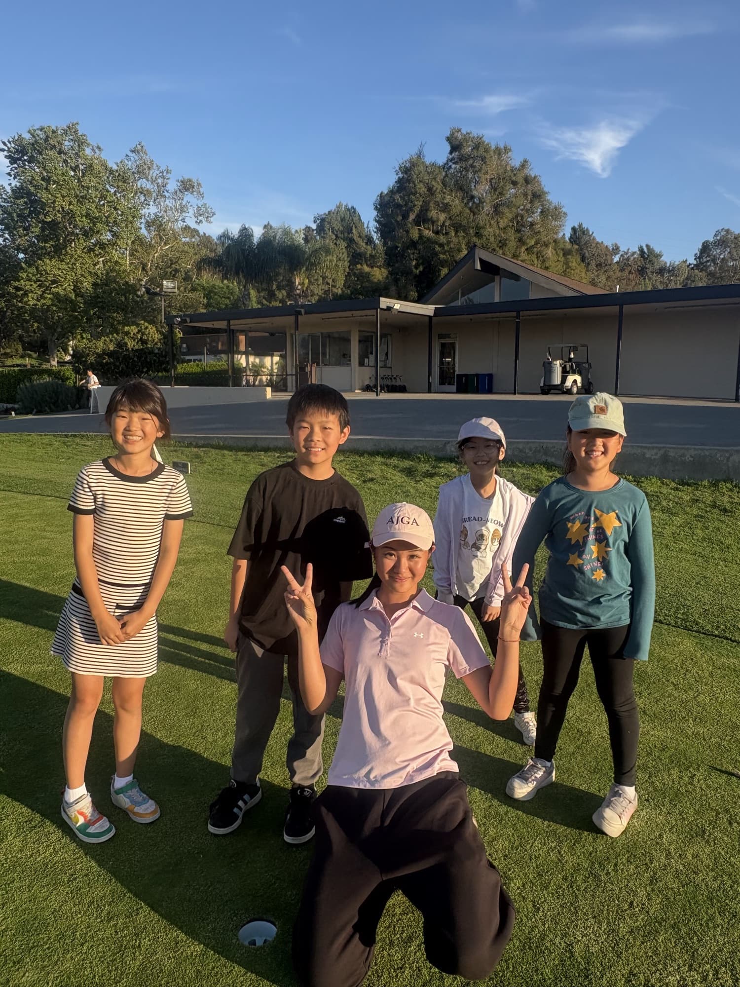 Jucchou Golf Junior Academy players with their coach on the course